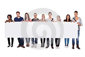 College students displaying blank billboard