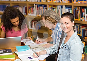 College students doing homework in library