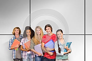Composite image of college students holding books in library