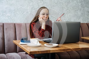 College students mental health. Sad and frustrated teenager student girl sitting with laptop and books