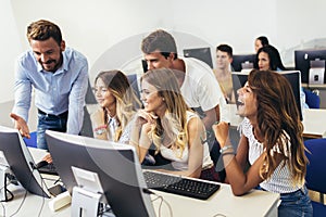 Students sitting in a classroom, using computers during class