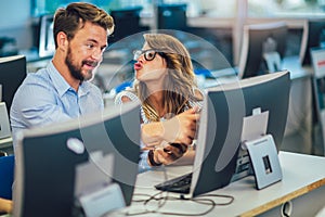 Students sitting in a classroom, using computers during class