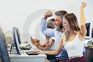 Students sitting in a classroom, using computers during class