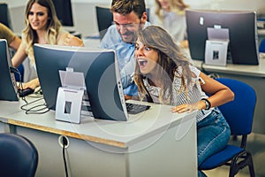 Students sitting in a classroom, using computers during class