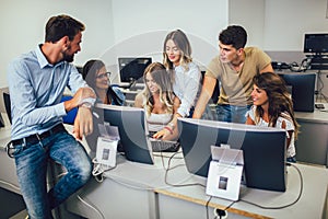 Students sitting in a classroom, using computers during class