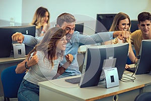 Students sitting in a classroom, using computers during class