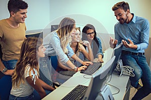 Students sitting in a classroom, using computers during class