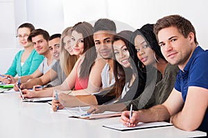 College students sitting in a row at desk