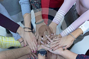 College Students Teamwork Stacking Hand Concept. Close up of young people putting their hands together. Friends with stack of