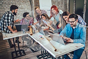 College students using laptop while sitting at table.