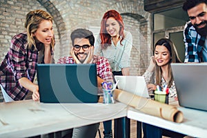 College students using laptop while sitting at table.