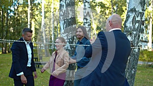 Collegues put up woman under the rope.