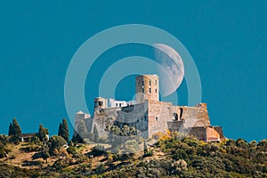 Collioure, France. moon moonrise above Fort Saint Elme In Sunny Spring Day. Old Medieval Fortress Saint-elme Is A