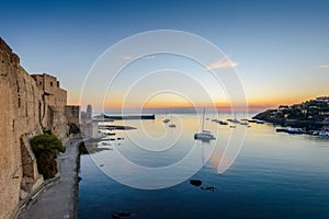 Collioure harbor and medieval castle at sunrise in France