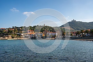 Collioure view from the other side of the bay with Fort of Saint Elme on the top of the village and the beach