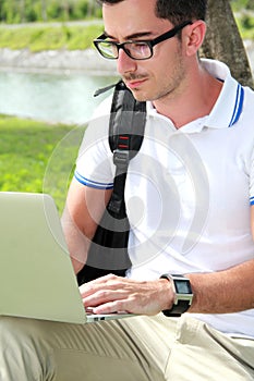 Colllege student working on assignments using laptop