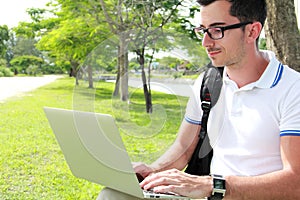 Colllege student working on assignments using laptop