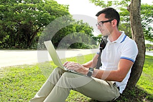 Colllege student working on assignments using laptop