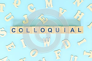 Colloquial language concept. Wooden blocks typography word flat lay in blue background. photo