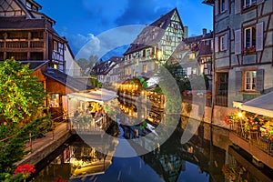 Colmar, France. Half-timbered houses and verandas of restaurants reflecting in the water