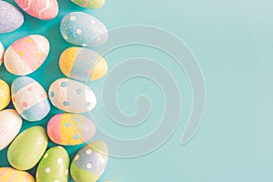 Coloeful easter eggs on pastel color background with space.