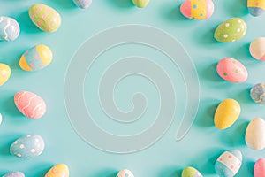 Coloeful easter eggs on pastel color background with space.