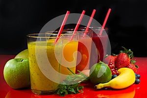 Colofrul fresh pressed fruit juices in tall glasses with fruits