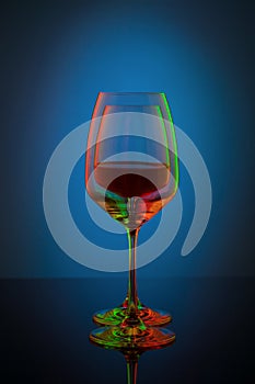 Coloful wineglass on table.