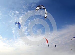 Colofull kites high in bright blue sky