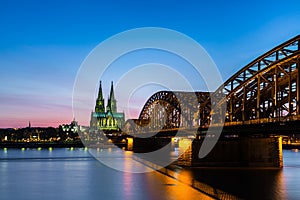 Cologne cathedral and hohenzollern bridge at sunset
