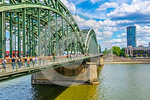 COLOGNE, GERMANY, AUGUST 11, 2018: People are passing on Hohenzollern bridge over Rhein during sunset, Germany