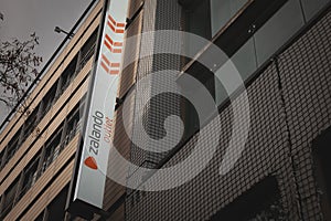 COLOGNE, GERMANY - NOVEMBER 6, 2022: Selective blur on a Zalando logo on their outlet store of Cologne. Zalando is an online