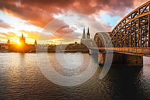 Cologne Skyline with Cathedral, Hohenzollern Bridge and Great St. Martin Church at sunset - Cologne, Germany