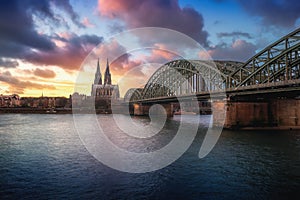 Cologne Skyline with Cathedral and Hohenzollern Bridge at sunset - Cologne, Germany