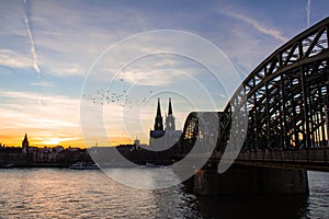 Cologne skyline with Cologne Cathedral and Hohenzollern bridge at sunset