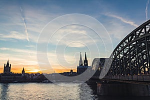 Cologne skyline with Cologne Cathedral and Hohenzollern bridge at sunset