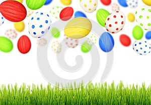 Cololrful Easter eggs falling at green grass