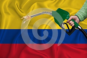 COLOMBIA flag Close-up shot on waving background texture with Fuel pump nozzle in hand. The concept of design solutions. 3d