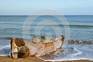 Colombian beach and old wooden dugout canoe