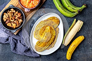 COLOMBIAN CARIBBEAN CENTRAL AMERICAN FOOD. Patacon or toston, fried and flattened whole green plantain banana on white