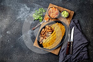 COLOMBIAN CARIBBEAN CENTRAL AMERICAN FOOD. Patacon or toston, fried and flattened whole green plantain banana on white