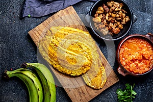 COLOMBIAN CARIBBEAN CENTRAL AMERICAN FOOD. Patacon or toston, fried and flattened whole green plantain banana on white