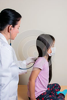 Colombian girl is examined by her pediatrician in the consulting room