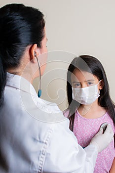 Colombian girl is examined by her pediatrician in the consulting room