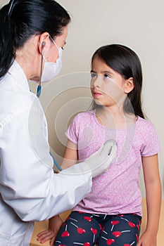 Colombian girl is examined by her pediatrician in the consulting room