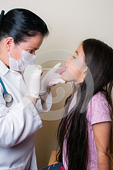 Colombian girl is examined by her pediatrician in the consulting room