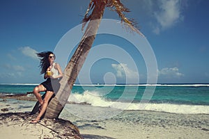 Colombian Girl in Vacation under a Palm Tree