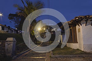 Colombian guatavita colonial town night scene of an empty brick peatonal path photo