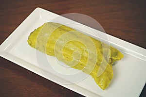 Colombian tamale recipe with steamed banana leaves photo