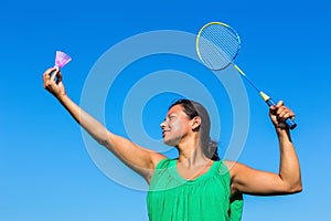 Colombian woman serve with badminton racket and shuttle